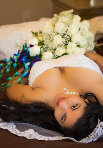 Bride On Bed With Bouquet